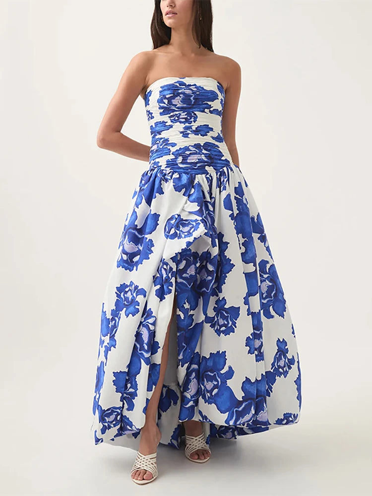 Woman wearing a strapless blue floral dress on a white background