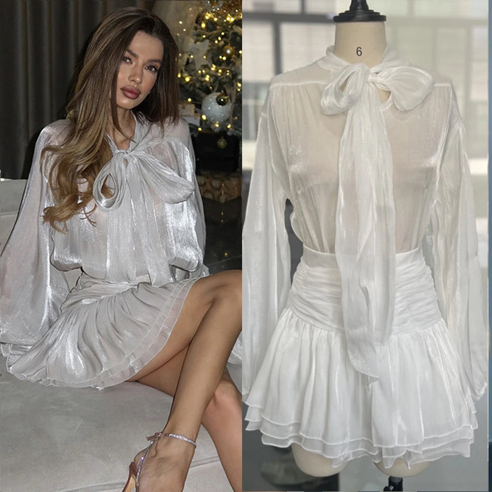 White sheer dress with a bow detail worn by a model and on a mannequin.