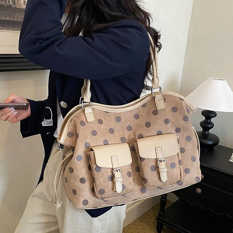 Beige polka dot faux leather tote bag with dual front pockets