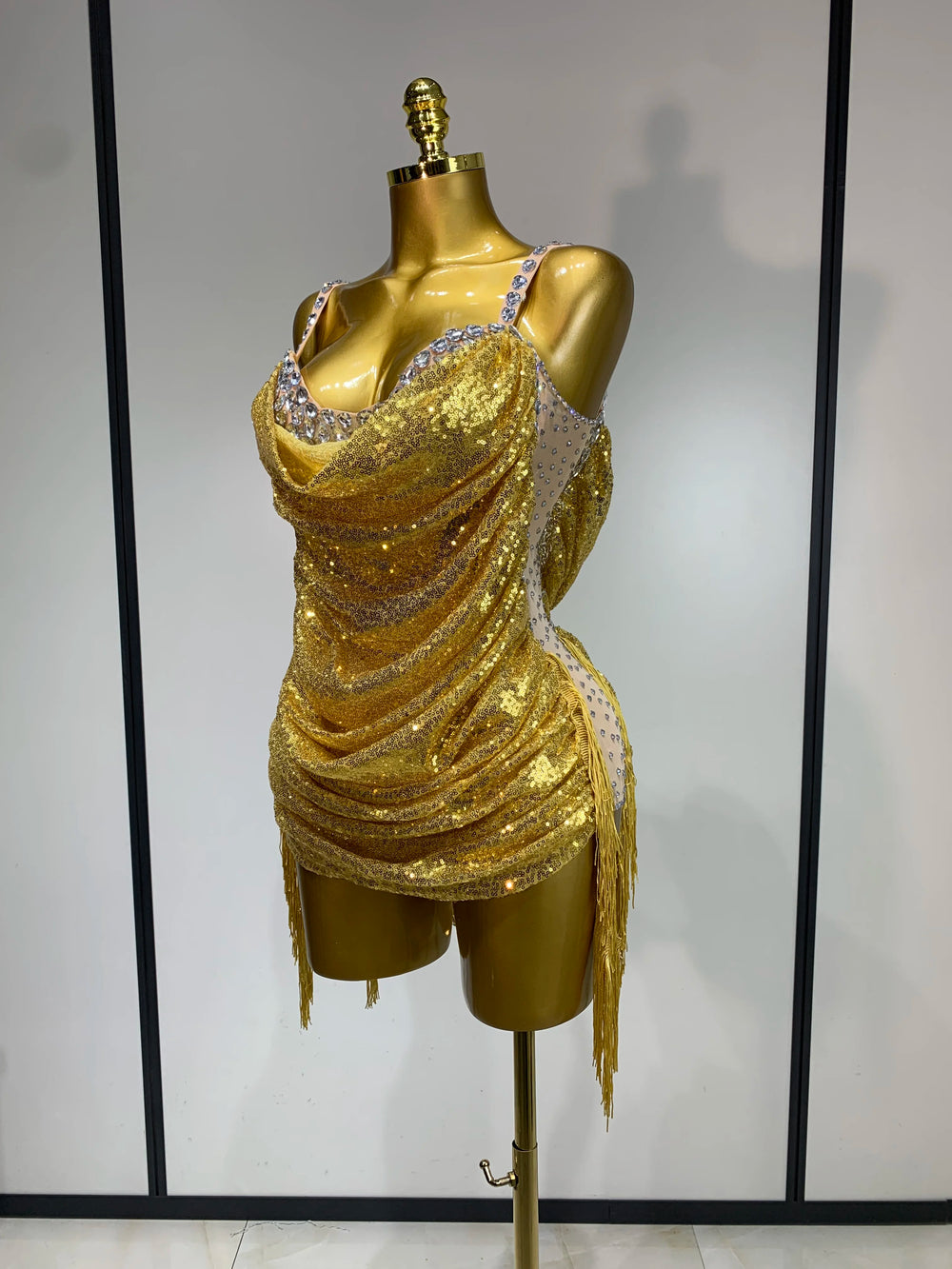 Side view of gold sequin cowl neck bodysuit