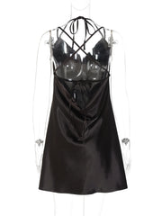 Black satin dress with criss-cross straps on a mannequin against a white background
