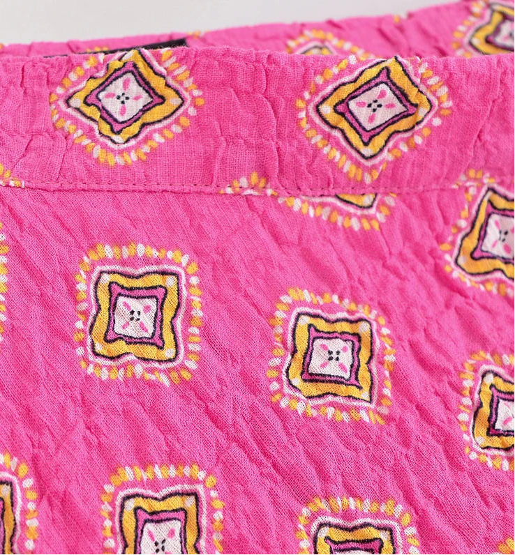Pink quilt with decorative patterns on a white background