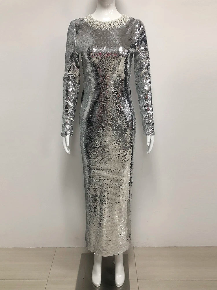 Silver sequin dress on a mannequin against a white background