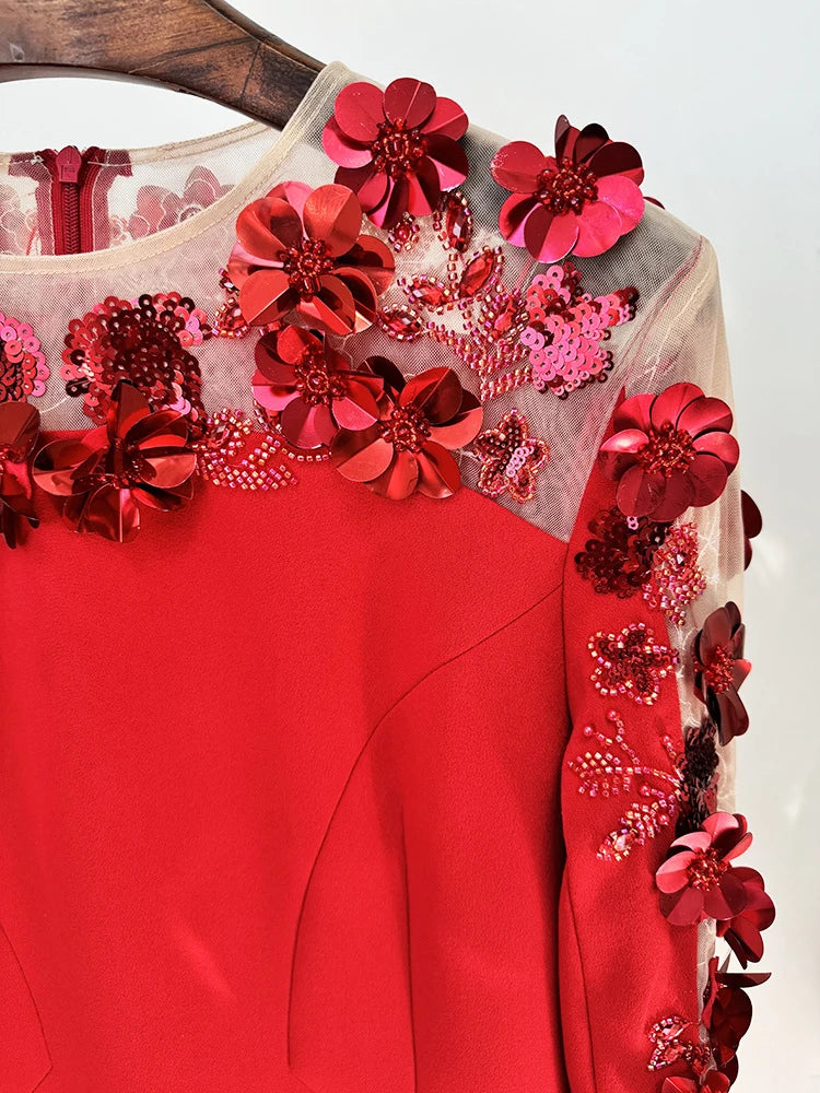 Red garment with floral embellishments on a white background