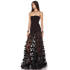 Strapless black maxi dress with dimensional floral appliques on skirt, angled view