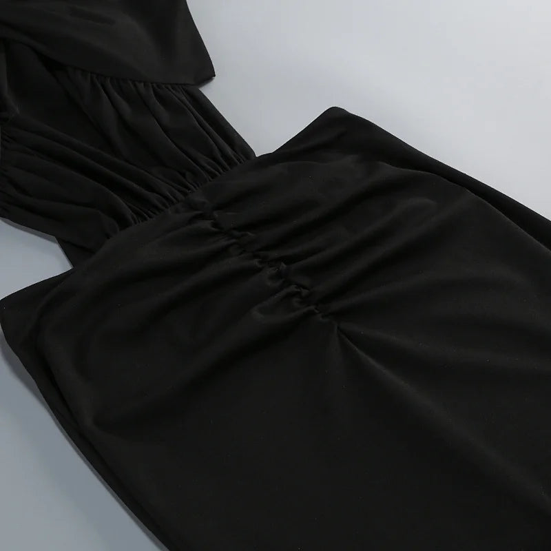 Close-up detail of the ruched waist on a black maxi dress