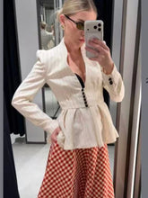 Striped peplum blazer jacket worn by a model.