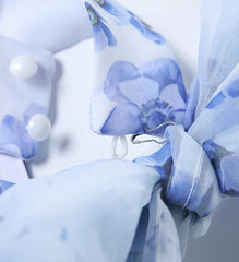 Close-up of a blue and white floral fabric with a blurred background