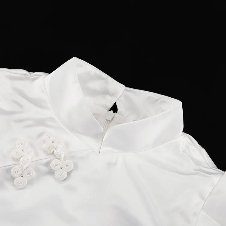 White blouse with floral details on a black background