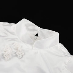 White blouse with floral details on a black background