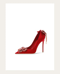 Red high-heeled shoe with floral embellishments on a white background