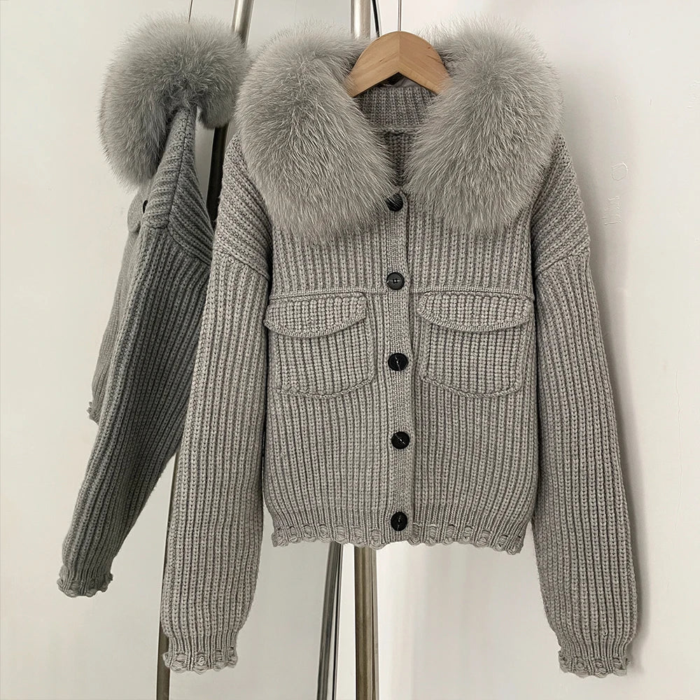 Grey ribbed knit jacket with a large natural grey fur collar.