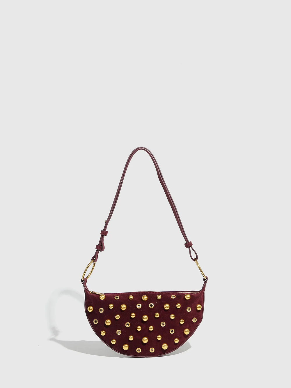 Maroon handbag with gold studs on a light gray background