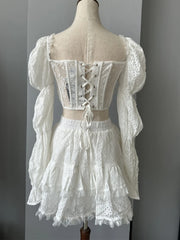 White lace dress on a mannequin against a gray background