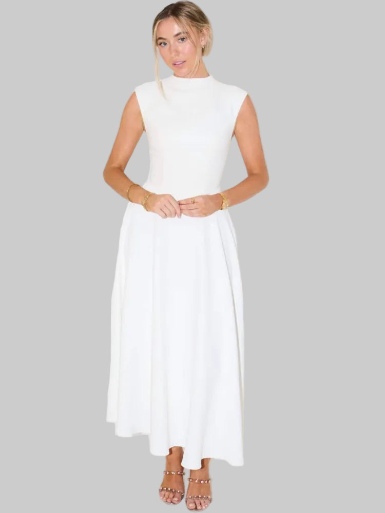 Woman wearing a white dress against a gray background