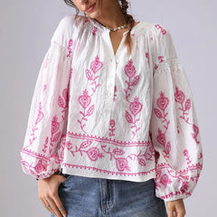 V-neck embroidered cotton blouse with pink floral details and lantern sleeves