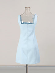 Light blue dress on a mannequin against a plain background