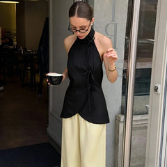 Black sleeveless high neck top with lace up waist detail