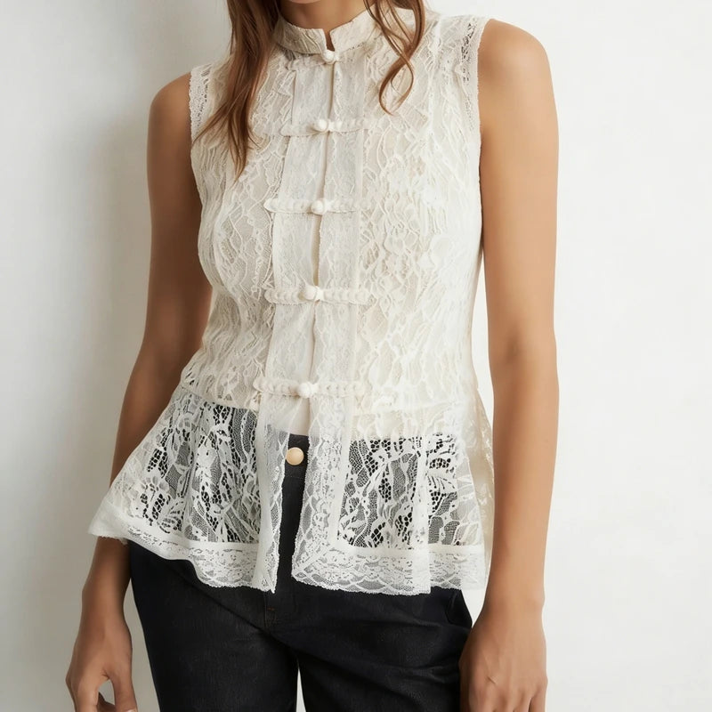 White lace sleeveless top worn by a person on a plain background