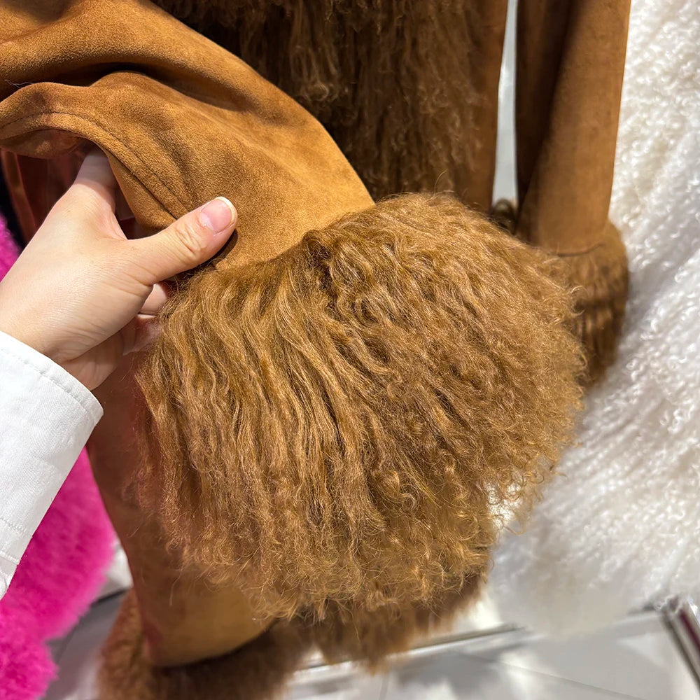 Close-up of a brown fur coat with a hand touching the fabric