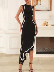 Woman wearing a black dress with white trim in an indoor setting