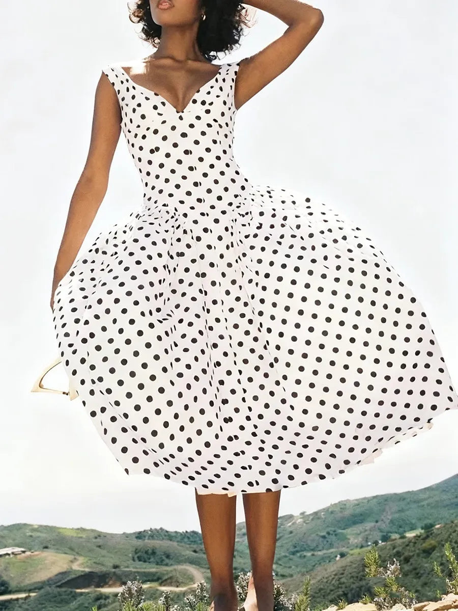 White sleeveless polka dot dress shown with a flared A-line skirt.