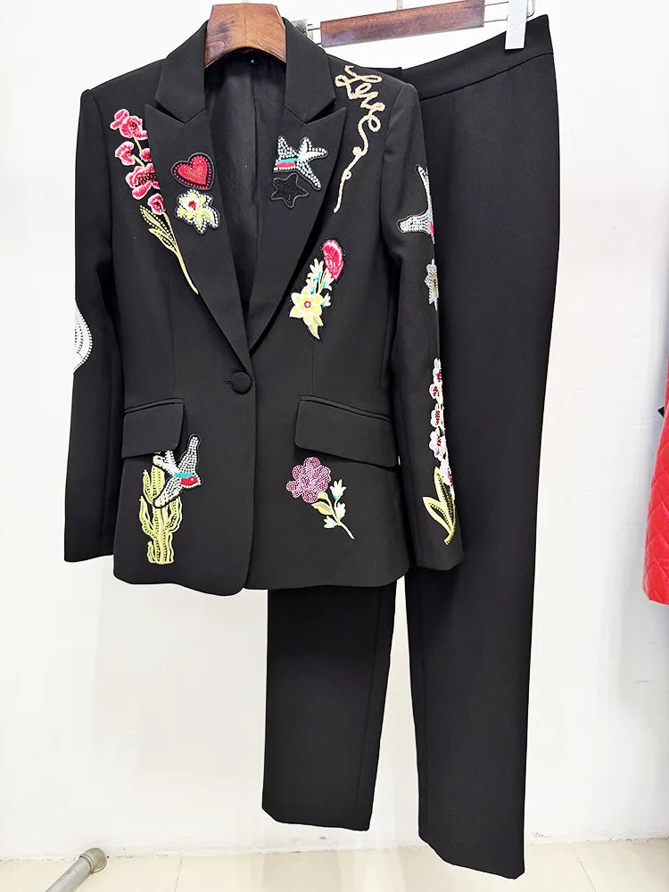 Black blazer and trousers suit displayed on a hanger