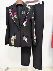 Black blazer and trousers suit displayed on a hanger