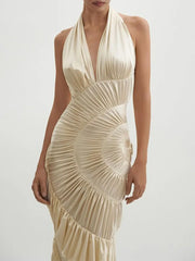 Beige halter neck dress on a white background