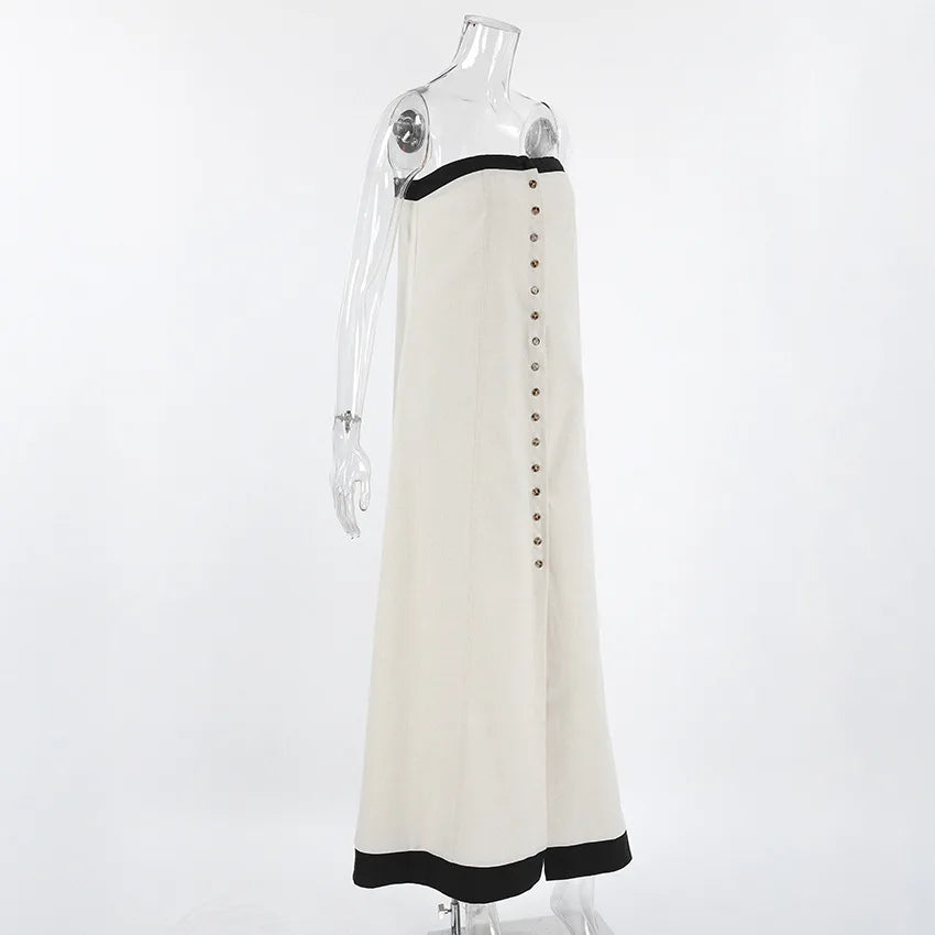 White dress with black trim and black buttons on a mannequin