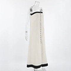 White dress with black trim and black buttons on a mannequin