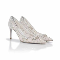 Pair of white high-heeled shoes with crystal embellishments on a white background