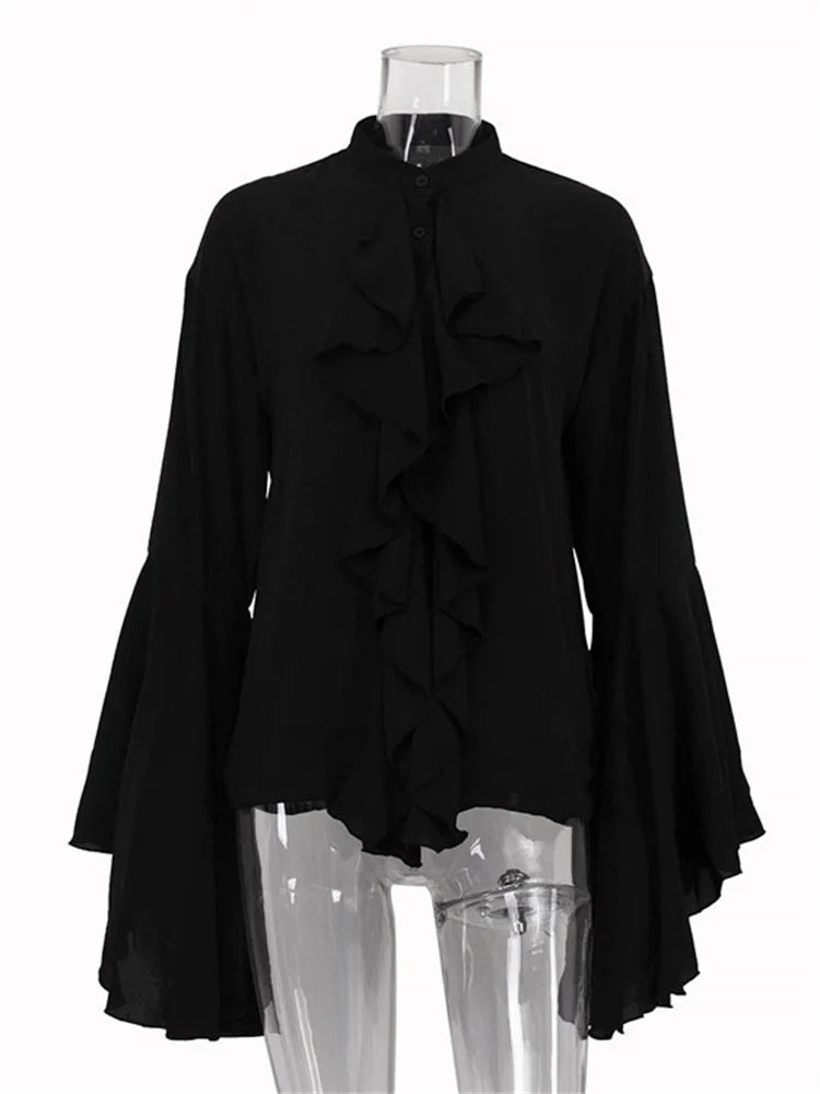 Black ruffled blouse on a mannequin against a white background