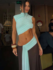 Woman wearing a light blue and brown dress in an indoor setting