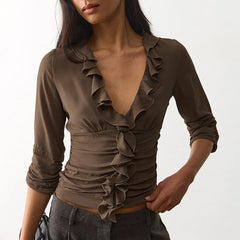 Brown ruffle V-neck cropped top with ruched bodice and three-quarter sleeves.