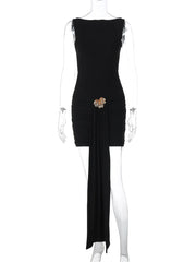 Black dress with floral embellishments on a mannequin against a white background