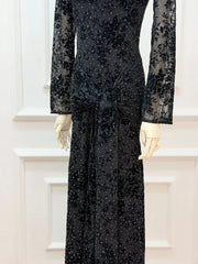 Black beaded evening gown on a mannequin with a white background