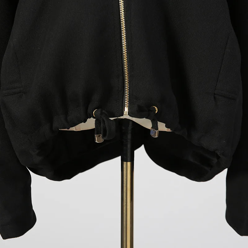 Black jacket with gold zipper on a white background