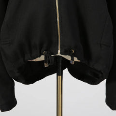 Black jacket with gold zipper on a white background