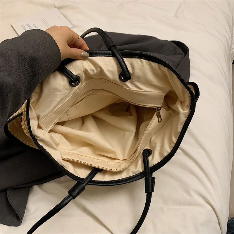 Black backpack with beige interior on a white surface