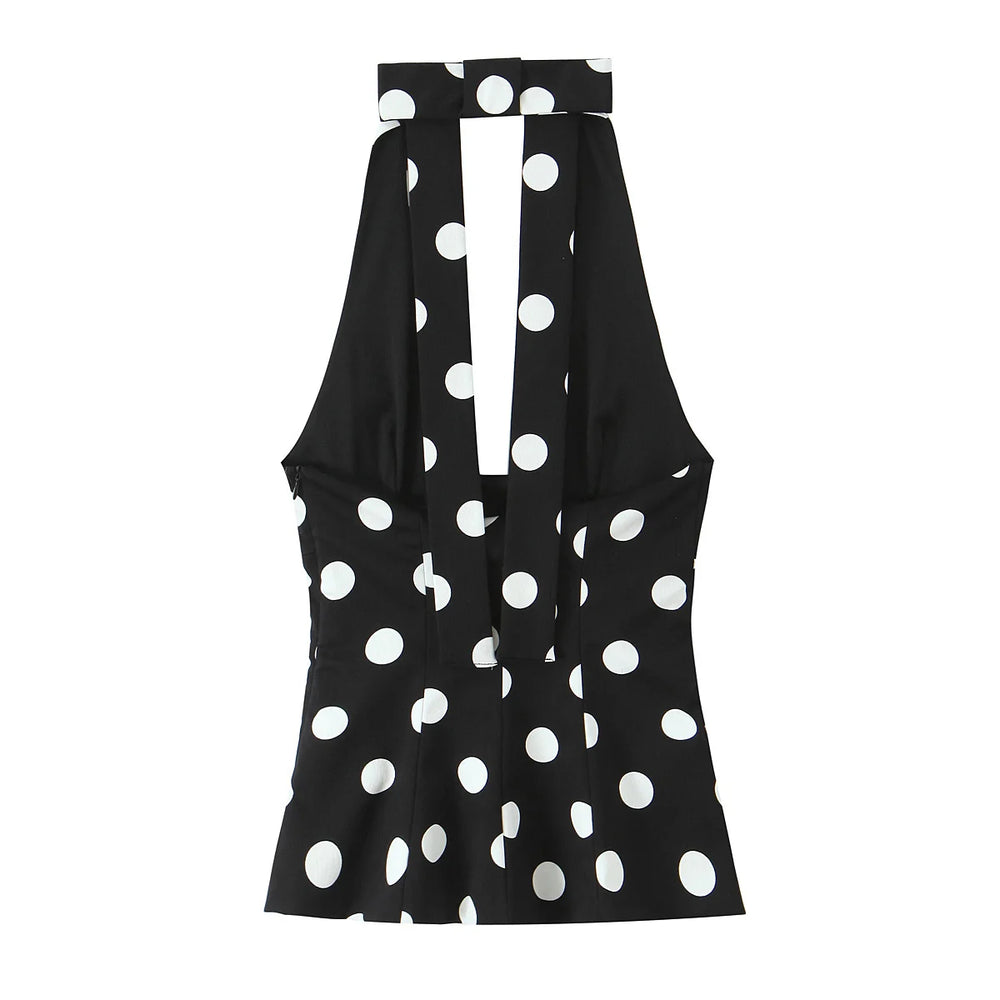 Black sleeveless top with white polka dot pattern on a white background