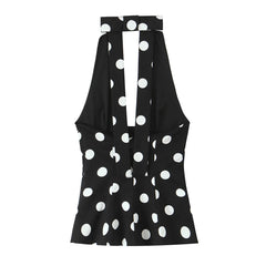 Black sleeveless top with white polka dot pattern on a white background