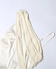 White dress on a hanger against a light gray background