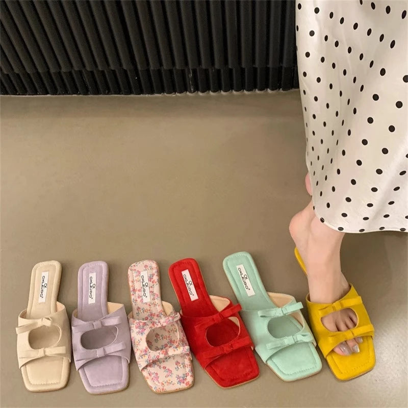 Colorful slides on a neutral floor with a person wearing one slide.