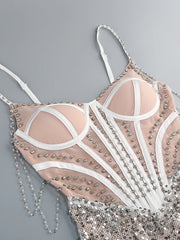 Decorative bra with rhinestones and chains on a gray background