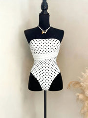 Polka dot bandeau one-piece swimsuit displayed on a mannequin