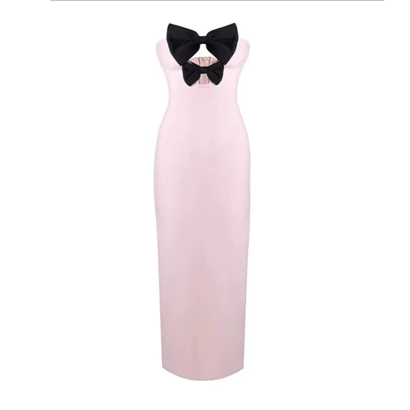 Pink dress with a black bow on a white background