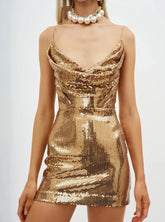 Gold sequin dress worn by a model on a white background