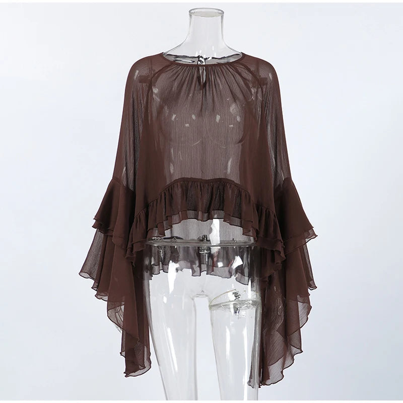 Brown sheer blouse on a mannequin against a white background