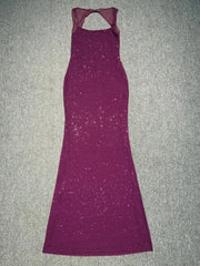 Purple evening gown on a textured gray surface